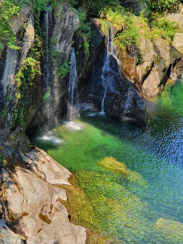 Beautiful natural waterfall and crystal-clear waters at Spiaggia di Santino Italy